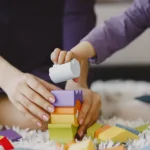 Childcare worker helping child