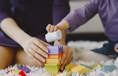 Childcare worker helping child